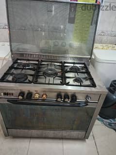 A 5-burner stove, an oven above and below, and heavy racks, all work g