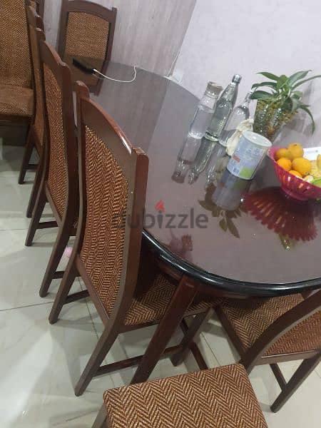 Oval shaped wooden dining table with 8 chairs 1
