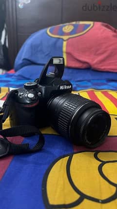Nikon D3200 with 18-55mm and free accessories.