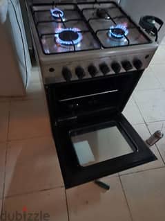 4-burner gas cooker with blue flame and oven underneath only