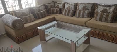 L-shaped sofa with glass center table