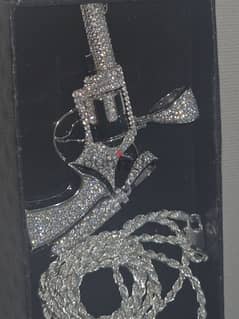 iced out revolver with chain and iced out bullet 0