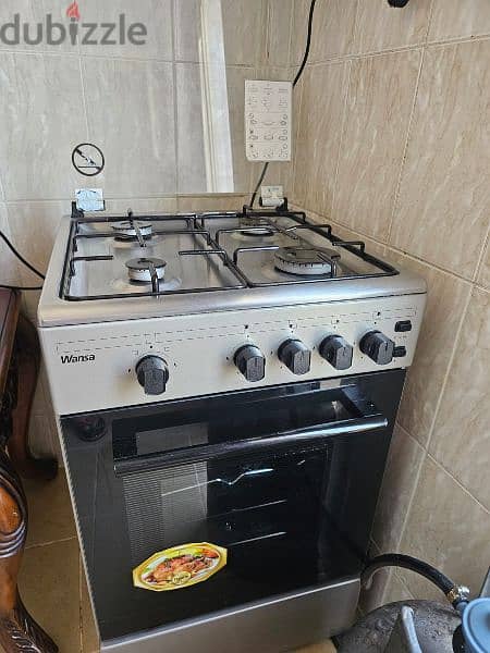 4 burner cooking range with a overhead for exhaust and gas cylinder 0