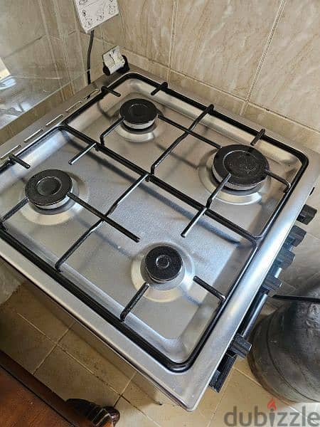 4 burner cooking range with a overhead for exhaust and gas cylinder 3