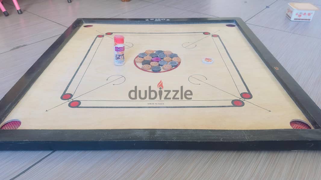 Carrom borad with coins and powder 1