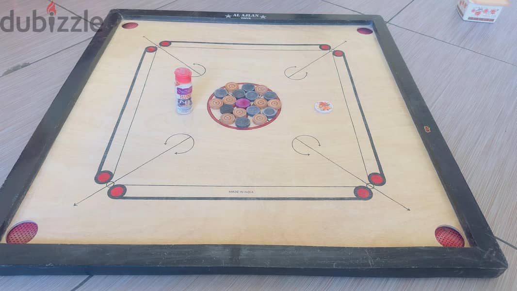 Carrom borad with coins and powder 2