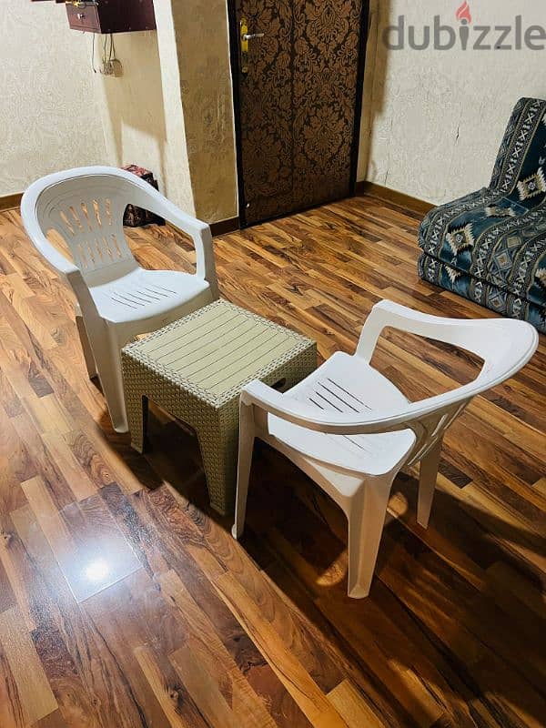 2 plastic chair and coffee table for sale 0