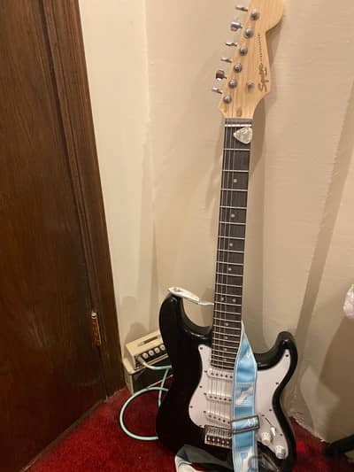 black fender electric guitar/ amplifier