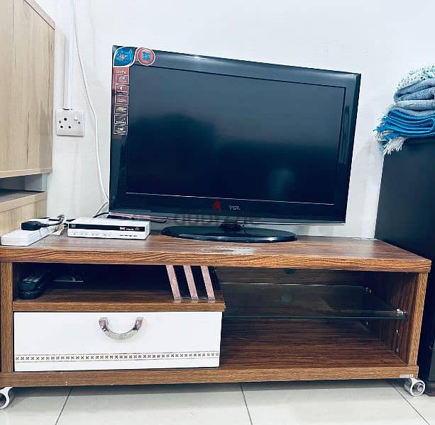 TCL brand TV with TV stand 0