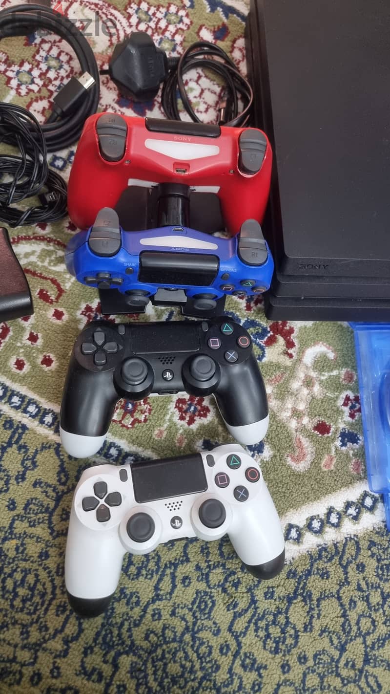 PS4 Pro with 4 controllers, 2 controller chargers and 3 games 1