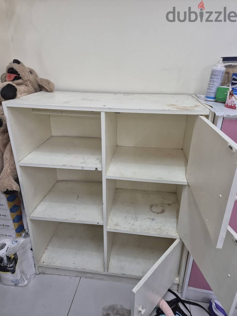 Small book rack with one side closed door. 2