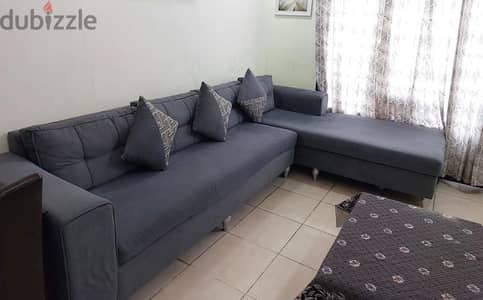 A big size sofa in grey colour in excellent condition