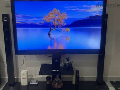 Tv with black stand with remote in good condition