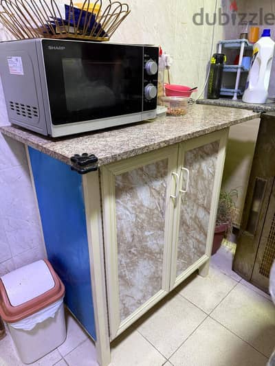microwave oven with kitchen cabinet with marble Slab