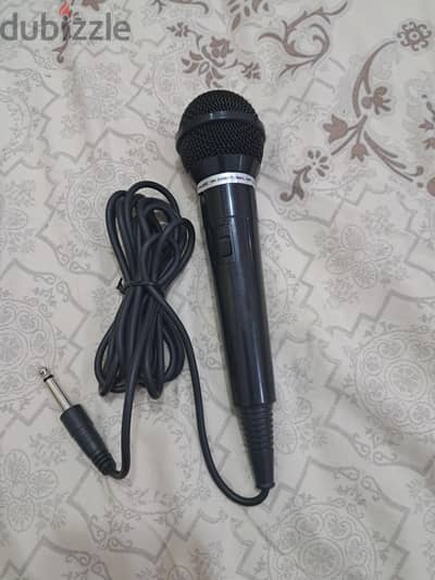 microphone with an attached cable and a 6.35mm audio plug