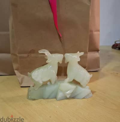 Hello, I have a jade stone sculpture featuring two beautifully carved