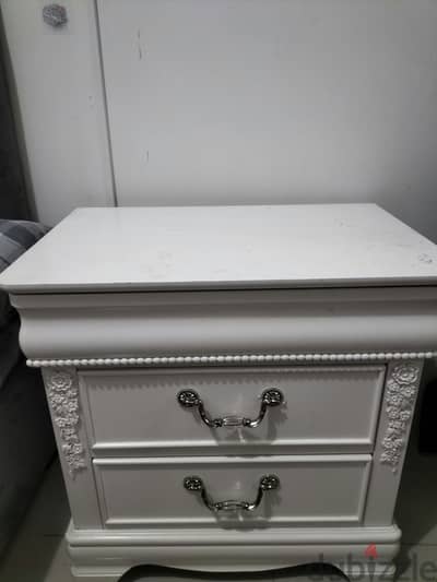 white, decorative 2-drawer bedside table with floral detailing. 