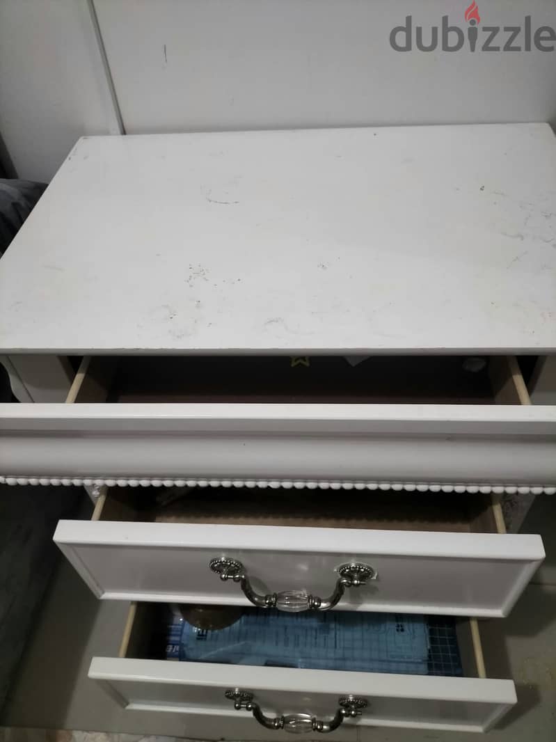 white, decorative 2-drawer bedside table with floral detailing.  1